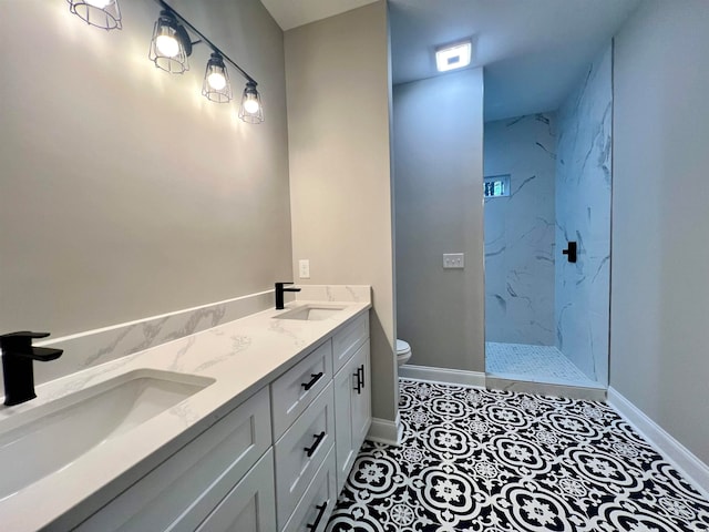 bathroom featuring tiled shower, tile patterned floors, vanity, and toilet