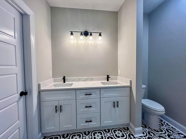 bathroom with tile patterned floors, vanity, and toilet