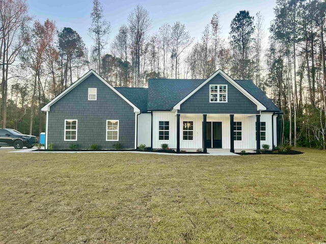 view of front of house with covered porch and a front yard