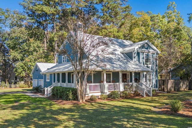 view of front facade featuring covered porch, a garage, an outdoor structure, and a front yard