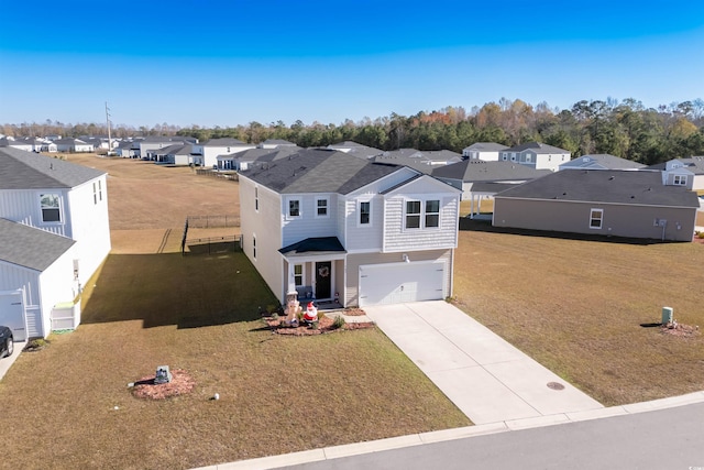 view of front of house with a front yard and a garage