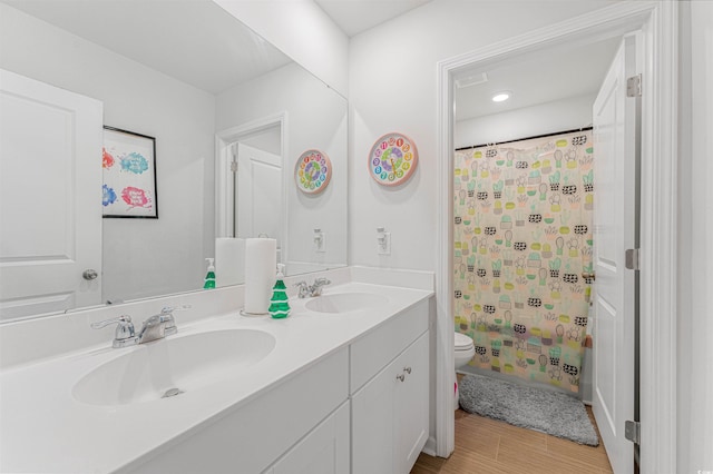 full bathroom featuring hardwood / wood-style floors, vanity, toilet, and shower / bath combo with shower curtain