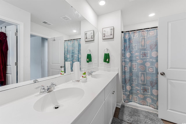 bathroom with a shower with curtain, vanity, and wood-type flooring