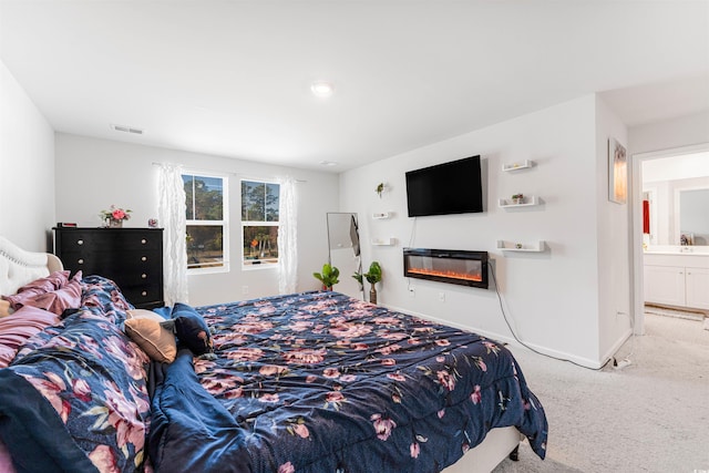 carpeted bedroom with connected bathroom