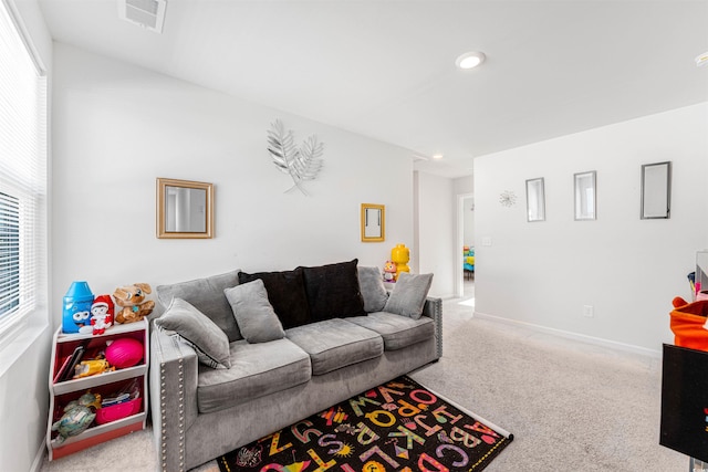 carpeted living room with a wealth of natural light