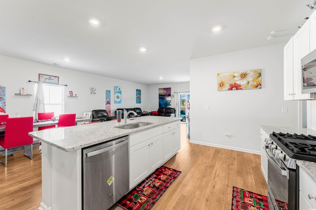 kitchen featuring sink, white cabinets, light hardwood / wood-style flooring, and appliances with stainless steel finishes