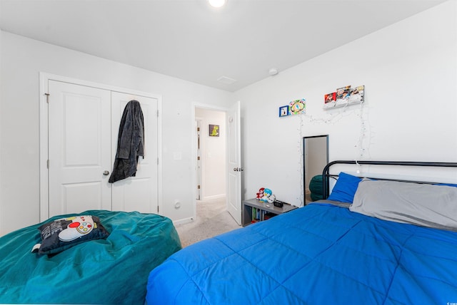 bedroom featuring a closet and light colored carpet