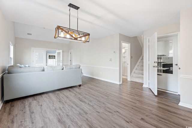 140 Wimbledon Way Unit 140, Murrells Inlet, SC 29576 - living area featuring stairway, wood finished floors, baseboards, and a chandelier