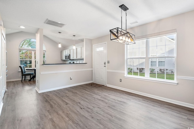 140 Wimbledon Way Unit 140, Murrells Inlet, SC 29576 - unfurnished dining area with a chandelier, wood finished floors, baseboards, lofted ceiling, and recessed lighting