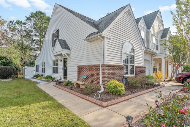140 Wimbledon Way Unit 140, Murrells Inlet, SC 29576 - view of side of home with a gate, brick siding, a lawn, and a shingled roof