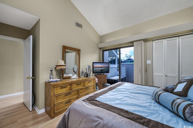 bedroom featuring high vaulted ceiling, light hardwood / wood-style floors, access to outside, and a closet