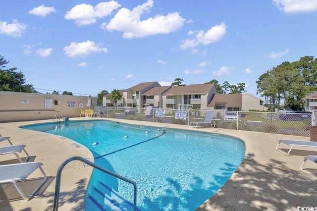 view of swimming pool with a patio area