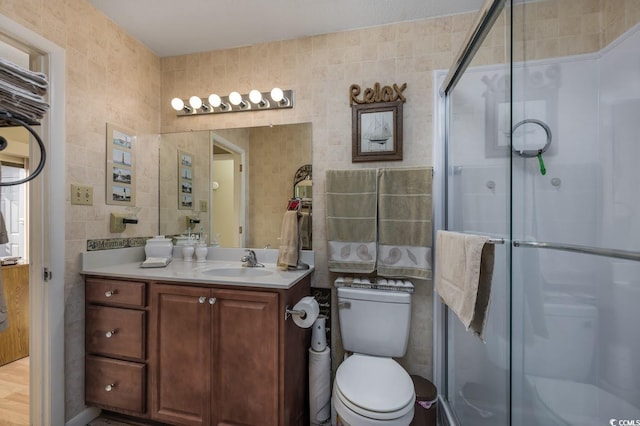 bathroom featuring vanity, an enclosed shower, and tile walls