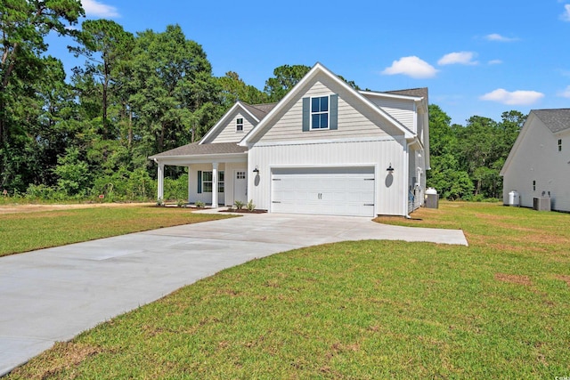 view of front of house featuring a garage, a front lawn, and cooling unit