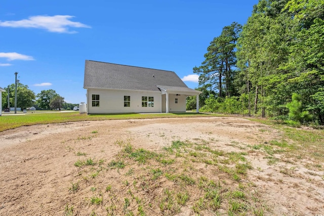 back of house with a lawn