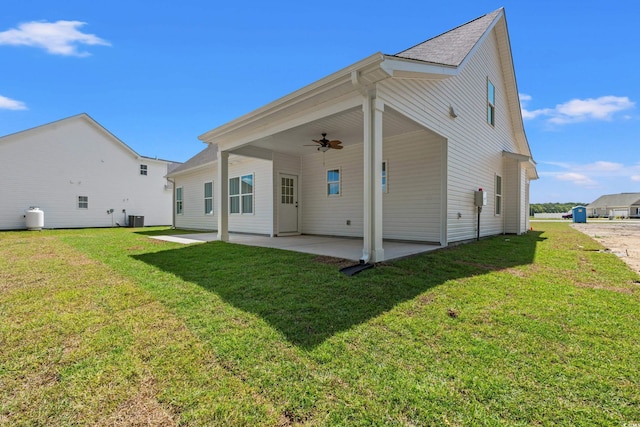 rear view of property with a patio, ceiling fan, and a lawn