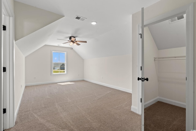 additional living space featuring carpet flooring, ceiling fan, and lofted ceiling