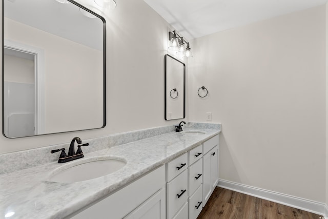 bathroom with hardwood / wood-style floors and vanity