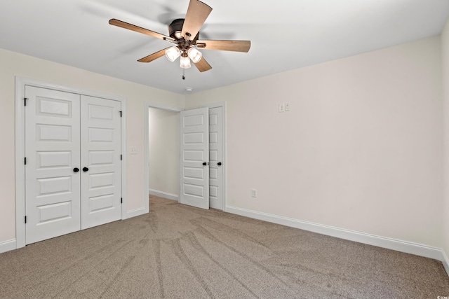 unfurnished bedroom with carpet, a closet, and ceiling fan