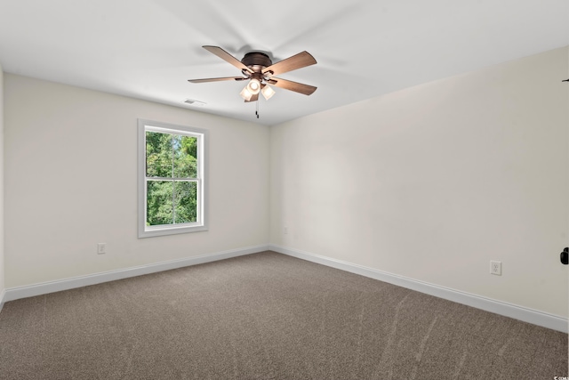 carpeted spare room with ceiling fan