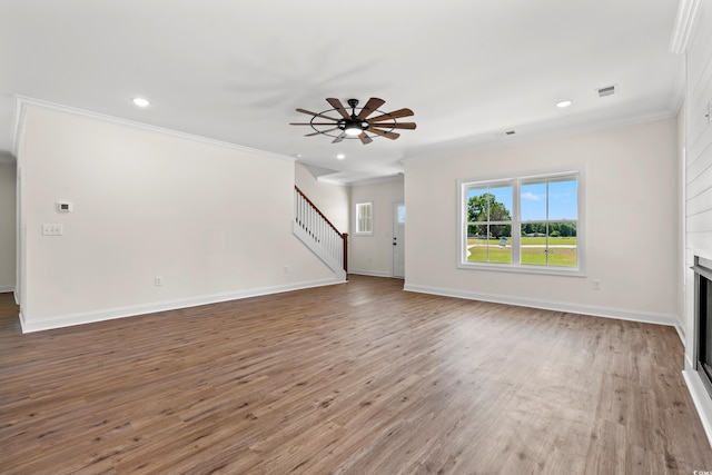 unfurnished living room with hardwood / wood-style flooring, ceiling fan, and ornamental molding