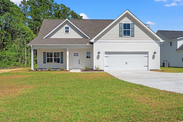 view of front of home featuring central AC, a front yard, and a garage