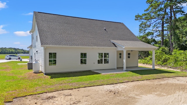 rear view of house with a patio area and a yard