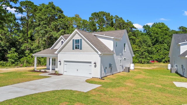 view of front of home with central AC unit, a garage, and a front lawn