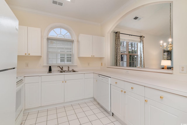 kitchen with plenty of natural light, sink, white cabinets, and white appliances