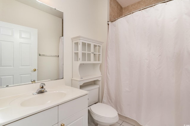 bathroom featuring tile patterned flooring, vanity, and toilet