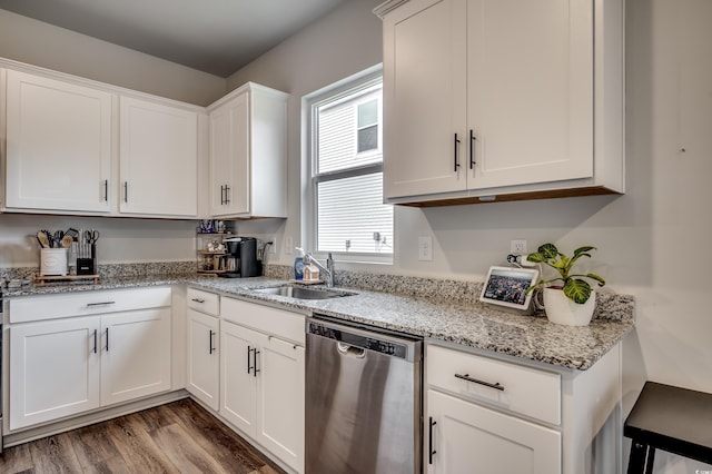 kitchen with dishwasher, wood-type flooring, white cabinetry, and sink