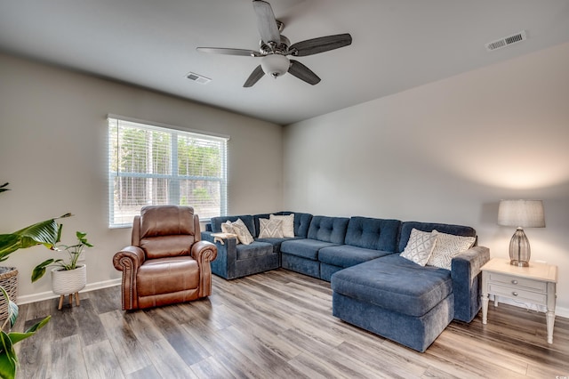 living room featuring hardwood / wood-style floors and ceiling fan