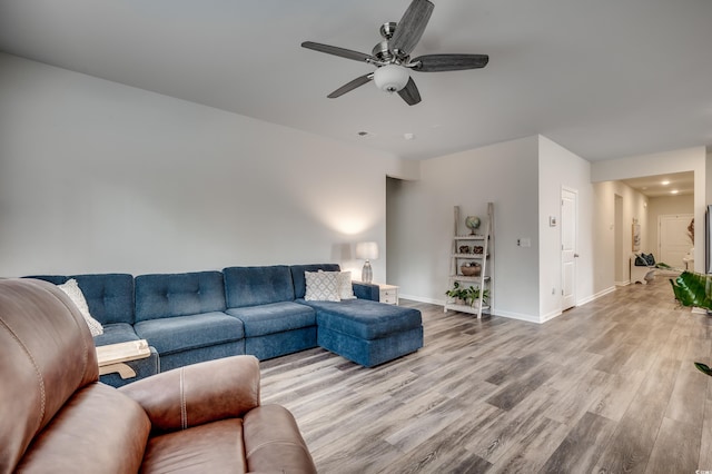 living room featuring ceiling fan and light hardwood / wood-style floors