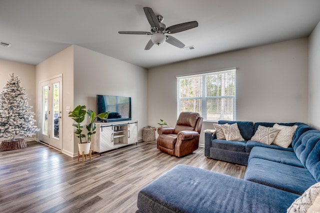 living room featuring hardwood / wood-style floors and ceiling fan