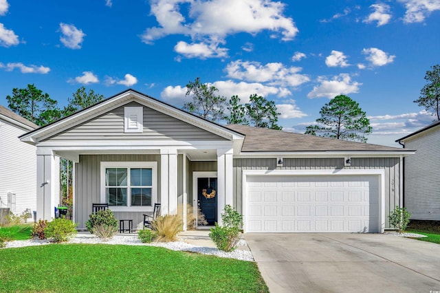 view of front of home with a garage and a front lawn