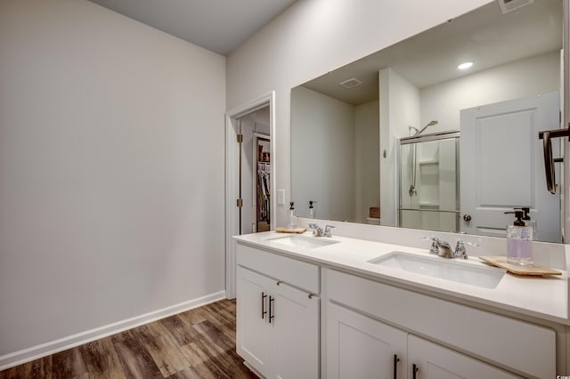 bathroom featuring hardwood / wood-style floors, vanity, and an enclosed shower