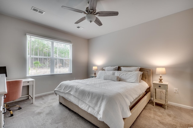 bedroom with ceiling fan and light colored carpet