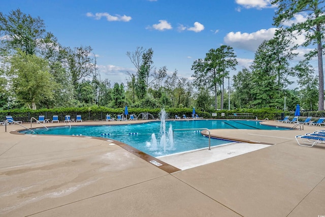 view of pool featuring pool water feature and a patio