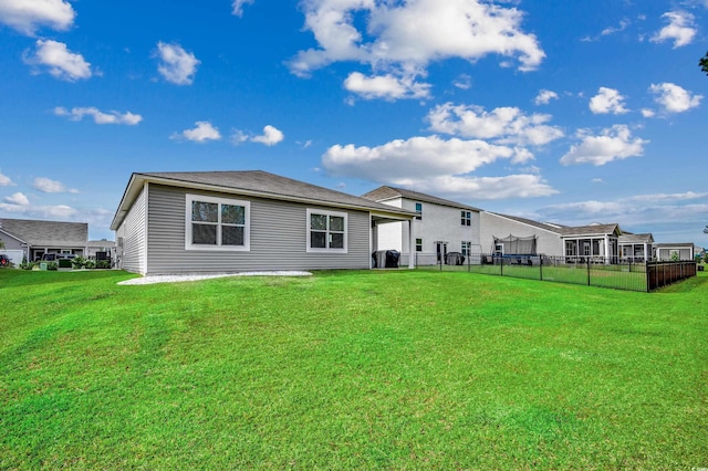 rear view of property featuring a yard