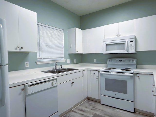 kitchen with white cabinets, light hardwood / wood-style floors, white appliances, and sink