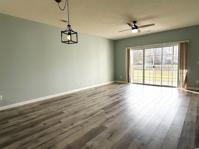 spare room featuring hardwood / wood-style flooring, ceiling fan, and a textured ceiling