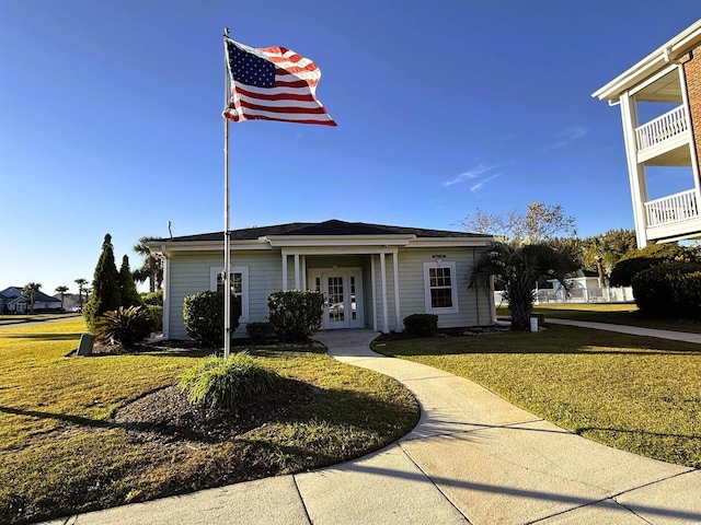 view of front of house featuring french doors and a front lawn