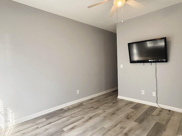 spare room with light hardwood / wood-style flooring and ceiling fan