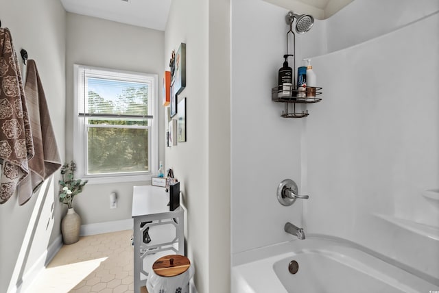 bathroom with tile patterned floors and shower / washtub combination