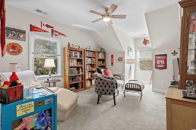 interior space featuring ceiling fan, lofted ceiling, and light carpet