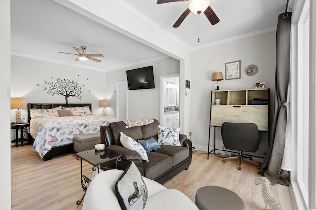 bedroom featuring connected bathroom, light hardwood / wood-style flooring, ceiling fan, and ornamental molding