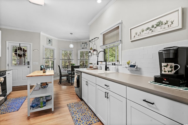 kitchen featuring pendant lighting, plenty of natural light, white cabinetry, and light wood-type flooring