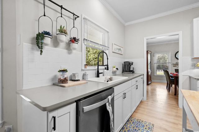 kitchen with white cabinetry, dishwasher, light wood-type flooring, and sink