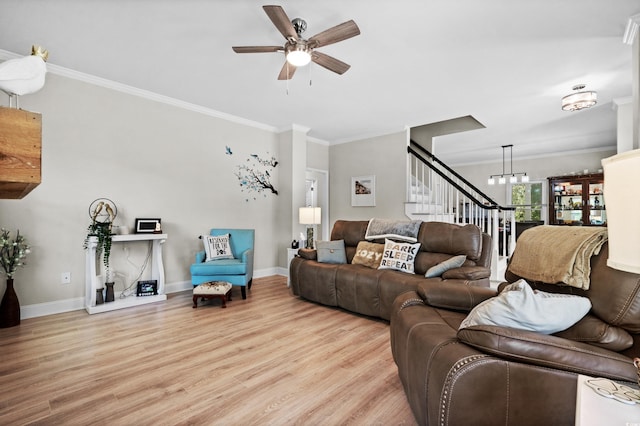 living room featuring ceiling fan with notable chandelier, light hardwood / wood-style flooring, and ornamental molding