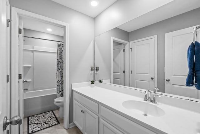 full bathroom with tile patterned flooring, shower / bath combo with shower curtain, vanity, and toilet